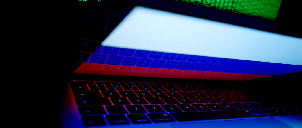 FILE PHOTO: A Russian flag is seen on the laptop screen in front of a computer screen on which cyber code is displayed, in this illustration picture taken March 2, 2018. REUTERS/Kacper Pempel/Illustration/File Photo  X02307