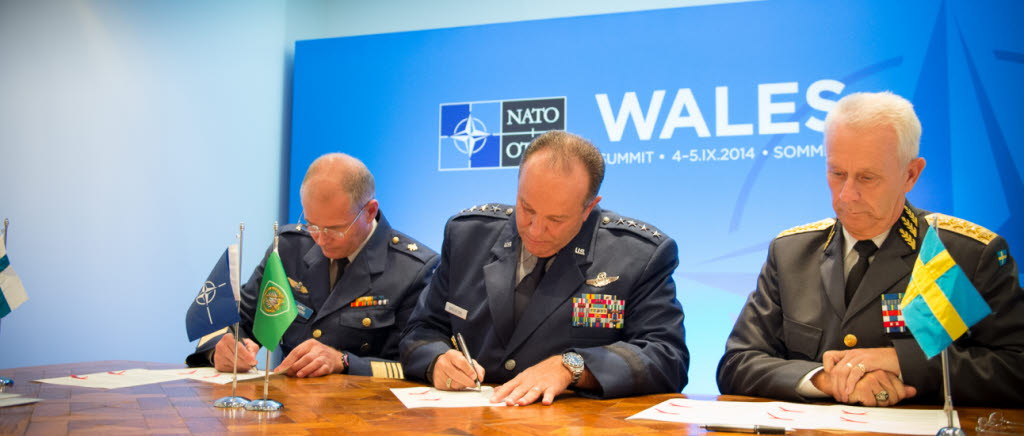 On September 4th, 2014, General Jarmo Lindberg (left), Finish Chief of Defense, General Phil Breedlove (center), Supreme Allied Commander Europe, and General Sverker GÃ¶ranson, Sweddish Chief of Defense, sign a Host Nation Support Agreement during the NATO Summit 2014 at Newport, The Wales, United Kingdom. This agreement is made to facilitate and officialize the presence of NATO troops during any type of missions on the host nation land.
(NATO photo by Edouard Bocquet)