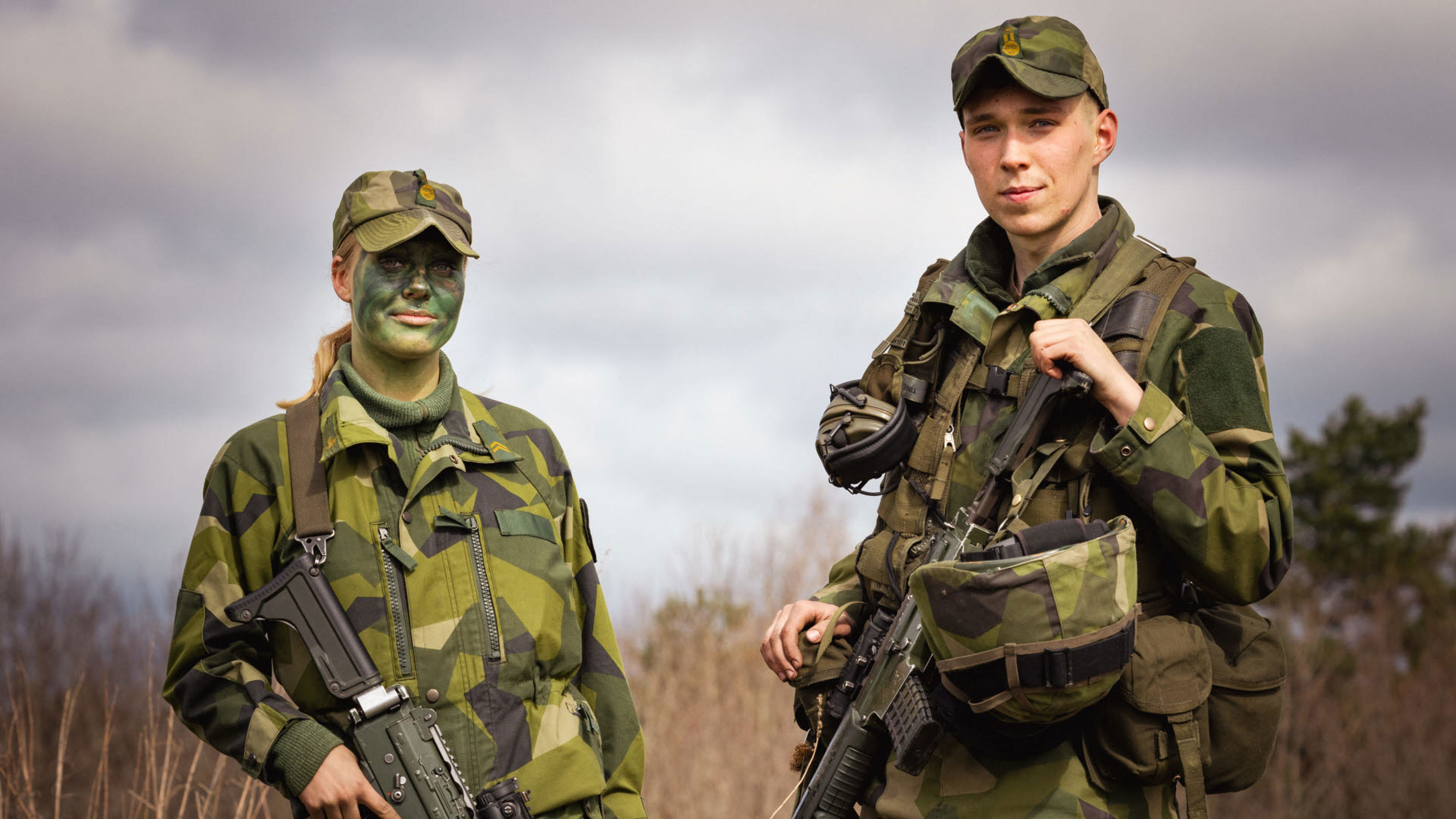 Två militära personer tittar in i kameran.